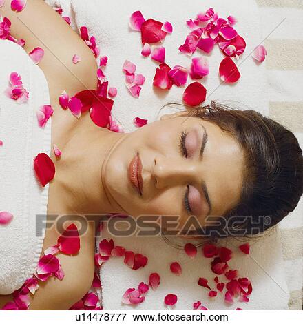 High angle view of a young woman lying on a massage table View Large Photo Image Stock Photo - High angle view of a young woman lying on a massage table. Fotosearch