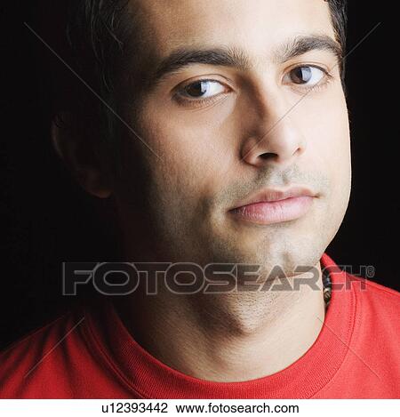 Stock Image - Portrait of a young man looking serious. Fotosearch