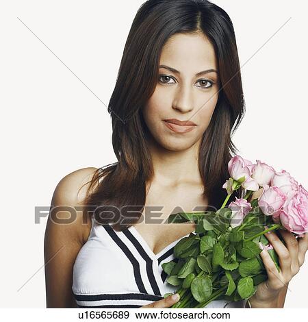 Stock Photo - Portrait of a young woman holding a bunch of roses. Fotosearch