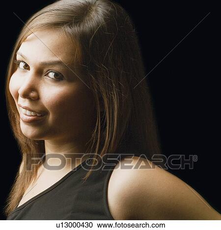 Stock Image - Portrait of a young woman smiling. Fotosearch