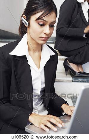 Businesswoman using a laptop View Large Photo Image Stock Image - Businesswoman using a laptop. Fotosearch