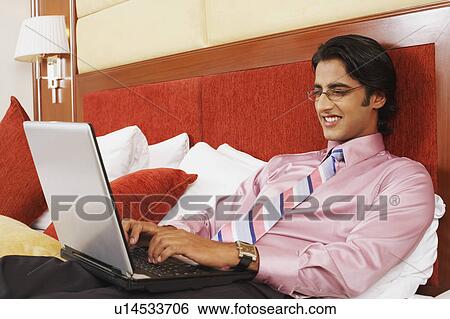 Stock Photograph - Close-up of a businessman using a laptop. Fotosearch