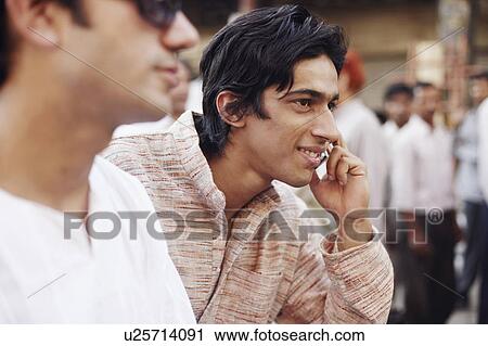 Stock Image - Close-up of a young man talking on a mobile phone. Fotosearch