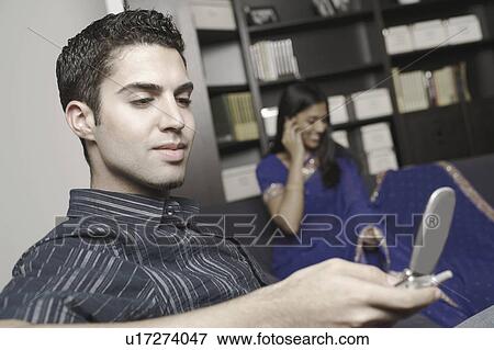 Close-up of a young man using a mobile phone View Large Photo Image Stock Photo - Close-up of a young man using a mobile phone. Fotosearch
