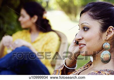 Picture - Close-up of a young woman talking on a mobile phone. Fotosearch