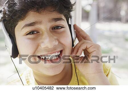 Portrait of a boy listening to music on headphones View Large Photo Image Stock Image - Portrait of a boy listening to music on headphones. Fotosearch