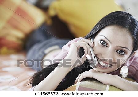 Stock Image - Portrait of a teenage girl talking on a mobile phone. Fotosearch