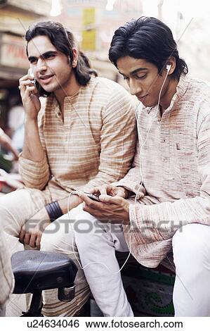 Two young men sitting in a rickshaw View Large Photo Image Stock Photograph - Two young men sitting in a rickshaw. Fotosearch