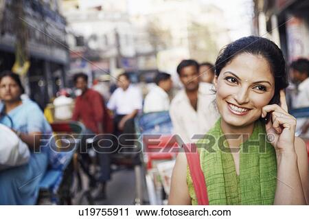 Young woman talking on a mobile phone View Large Photo Image Stock Image - Young woman talking on a mobile phone. Fotosearch