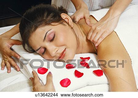Close-up of a young woman getting a shoulder massage from a massage therapist View Large Photo Image Picture - Close-up of a young woman getting a shoulder massage from a massage therapist. Fotosearch
