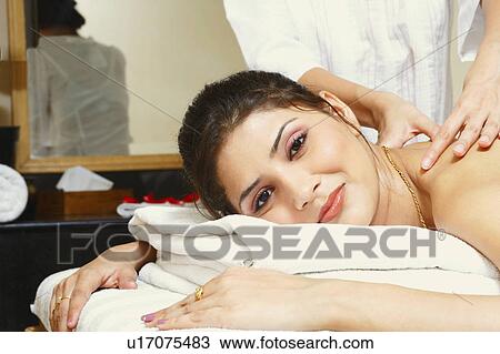 Portrait of a young woman getting a shoulder massage from a massage therapist View Large Photo Image Stock Image - Portrait of a young woman getting a shoulder massage from a massage therapist. Fotosearch