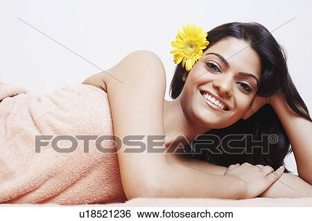 Stock Photograph - Portrait of a young woman smiling in a towel. Fotosearch