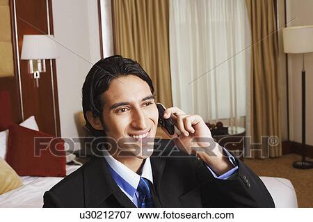 Businessman talking on a mobile phone View Large Photo Image Stock Photo - Businessman talking on a mobile phone. Fotosearch