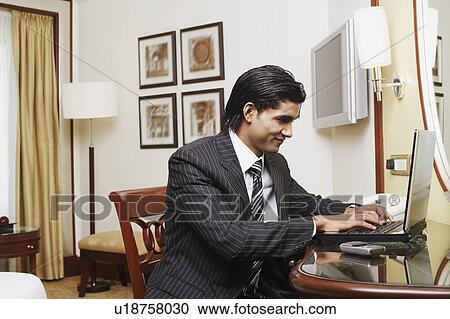 Businessman using a laptop View Large Photo Image Stock Image - Businessman using a laptop. Fotosearch