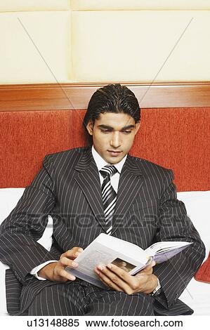 Stock Photography - Close-up of a businessman reading a book. Fotosearch