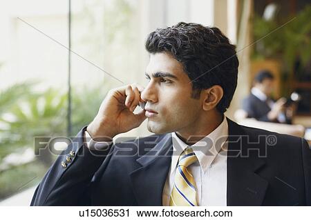 Close-up of a businessman talking on a mobile phone View Large Photo Image Stock Image - Close-up of a businessman talking on a mobile phone. Fotosearch
