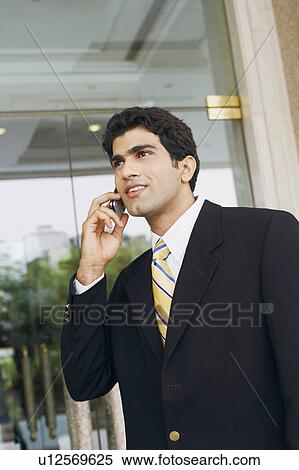 Stock Photography - Close-up of a businessman talking on a mobile phone. Fotosearch