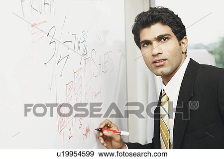 Stock Photo - Close-up of a businessman writing on a whiteboard. Fotosearch