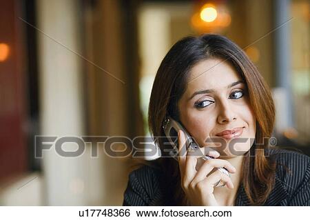 Close-up of a businesswoman talking on a mobile phone View Large Photo Image Stock Photograph - Close-up of a businesswoman talking on a mobile phone. Fotosearch