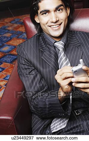 Portrait of a businessman using a mobile phone View Large Photo Image Stock Photo - Portrait of a businessman using a mobile phone. Fotosearch