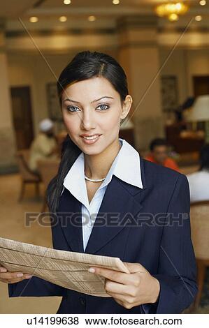 Portrait of a businesswoman holding a newspaper View Large Photo Image Stock Photo - Portrait of a businesswoman holding a newspaper. Fotosearch