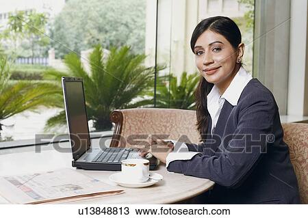 Portrait of a businesswoman operating a laptop View Large Photo Image Stock Image - Portrait of a businesswoman operating a laptop. Fotosearch