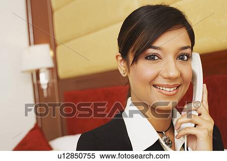 Stock Photography - Portrait of a businesswoman talking on the telephone. Fotosearch
