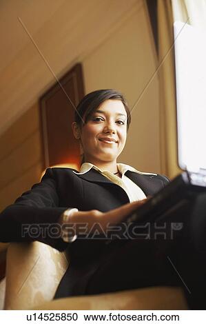 Stock Image - Portrait of a businesswoman using a laptop. Fotosearch