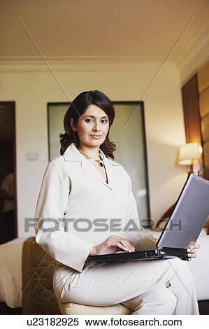 Portrait of a businesswoman using a laptop View Large Photo Image Stock Photography - Portrait of a businesswoman using a laptop. Fotosearch