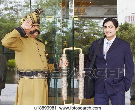 Portrait of a security guard saluting a businessman View Large Photo Image Stock Image - Portrait of a security guard saluting a businessman. Fotosearch