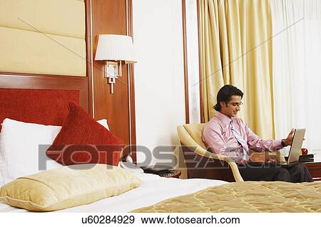 Side profile of a businessman using a laptop View Large Photo Image Stock Photo - Side profile of a businessman using a laptop. Fotosearch