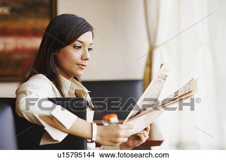 Side profile of a businesswoman reading a newspaper View Large Photo Image Picture - Side profile of a businesswoman reading a newspaper. Fotosearch