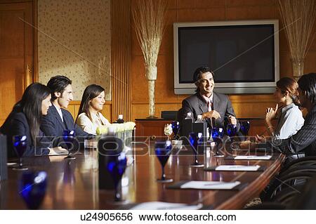 Business executives sitting in a conference room and discussing View Large Photo Image Stock Photograph - Business executives sitting in a conference room and discussing. Fotosearch