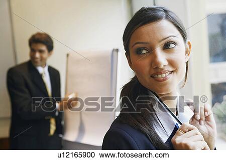 Stock Image - Close-up of a businesswoman looking sideways. Fotosearch