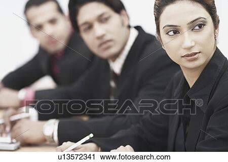 Close-up of a businesswoman sitting with two businessmen View Large Photo Image Stock Image - Close-up of a businesswoman sitting with two businessmen. Fotosearch