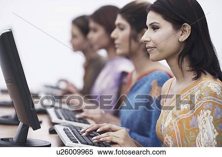Close-up of four businesswomen sitting in front of computers View Large Photo Image Stock Photography - Close-up of four businesswomen sitting in front of computers. Fotosearch