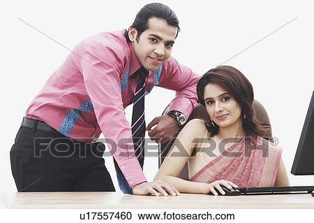 Stock Image - Portrait of a businesswoman and a businessman smiling. Fotosearch