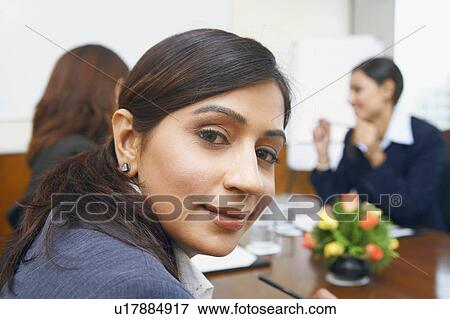 Portrait of a businesswoman sitting in a conference room View Large Photo Image Stock Photo - Portrait of a businesswoman sitting in a conference room. Fotosearch