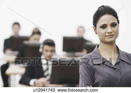 Stock Image - Portrait of a businesswoman standing in an office. Fotosearch