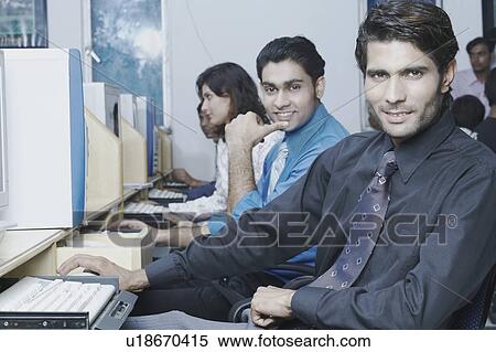Stock Photography - Portrait of a male office worker in an office. Fotosearch
