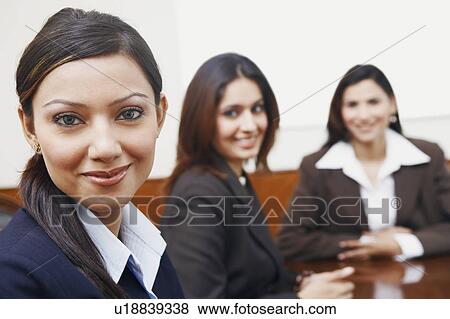 Portrait of three businesswomen sitting in a conference room View Large Photo Image Stock Photo - Portrait of three businesswomen sitting in a conference room. Fotosearch
