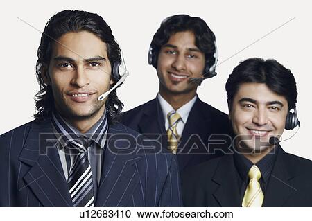 Stock Image - Portrait of three male customer service representatives smiling. Fotosearch