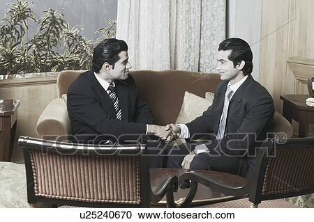 Side profile of two businessmen shaking hands View Large Photo Image Stock Image - Side profile of two businessmen shaking hands. Fotosearch