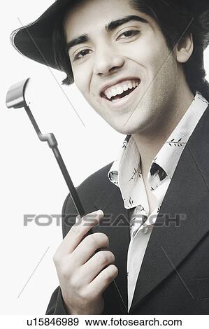 Portrait of a young man holding a golf club View Large Photo Image Stock Photo - Portrait of a young man holding a golf club. Fotosearch