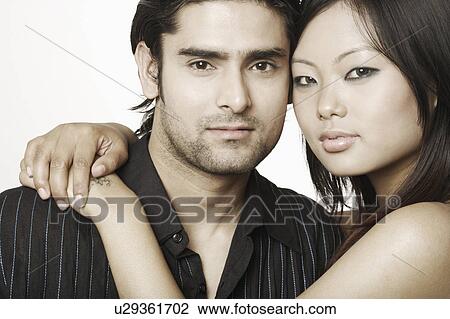 Portrait of a young woman embracing a young man View Large Photo Image Stock Image - Portrait of a young woman embracing a young man. Fotosearch