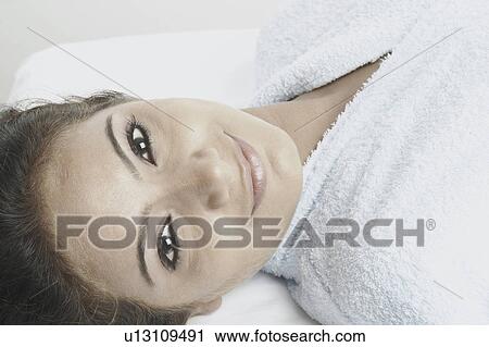 Portrait of a young woman lying on a massage table View Large Photo Image Stock Image - Portrait of a young woman lying on a massage table. Fotosearch