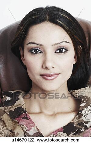 Stock Image - Portrait of a young woman smiling. Fotosearch