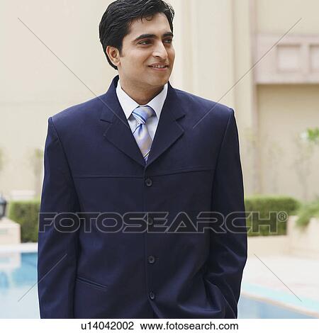 Close-up of a businessman smiling and looking away View Large Photo Image Stock Image - Close-up of a businessman smiling and looking away. Fotosearch