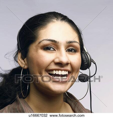 Stock Image - Close-up of a female customer service representative wearing a headset. Fotosearch