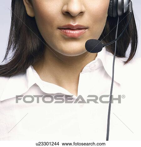 Mid section view of a female customer service representative wearing a headset View Large Photo Image Picture - Mid section view of a female customer service representative wearing a headset. Fotosearch